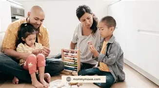 A group of diverse children standing in a circle with their hands raised