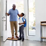 A child in school uniform with a backpack
