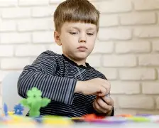 A teacher working with a child on social skills